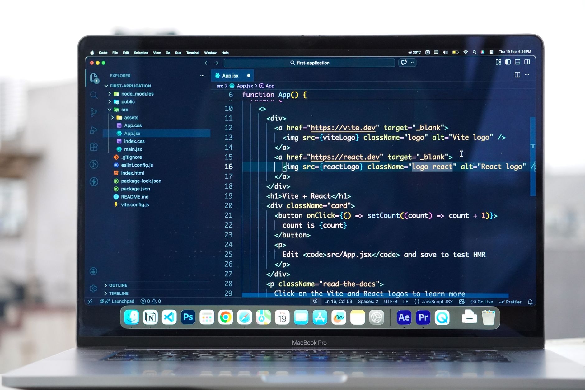 Laptop with code editor open on a rooftop, showcasing remote web development and modern work flexibility.